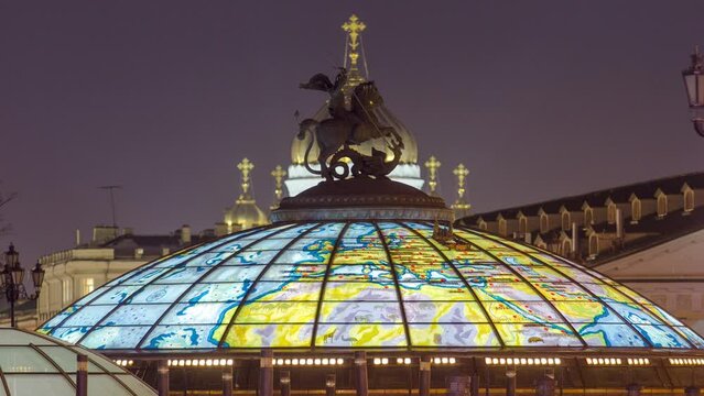 Night Timelapse of Glass Cupola with Saint George Statue at Manege Square, Moscow, Russia. Christ the Savior Cathedral in the Background