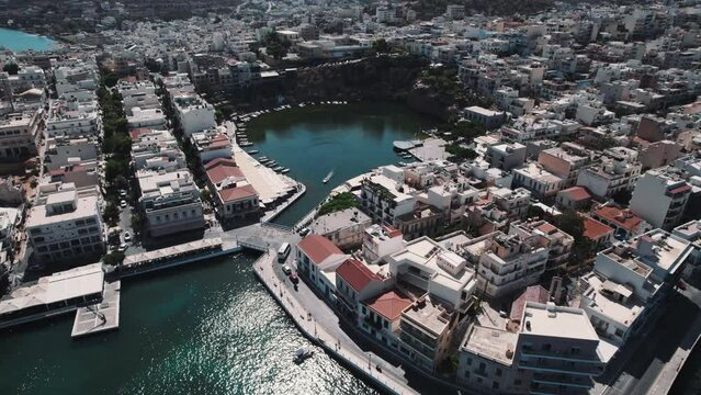 Aerial view of streets, buildings and Voulismeni Lake in Agios Nikolaos Crete, Greece. High angle view. High quality 4k footage