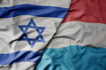 big waving national colorful flag of israel and national flag of luxembourg . - obrazy, fototapety, plakaty