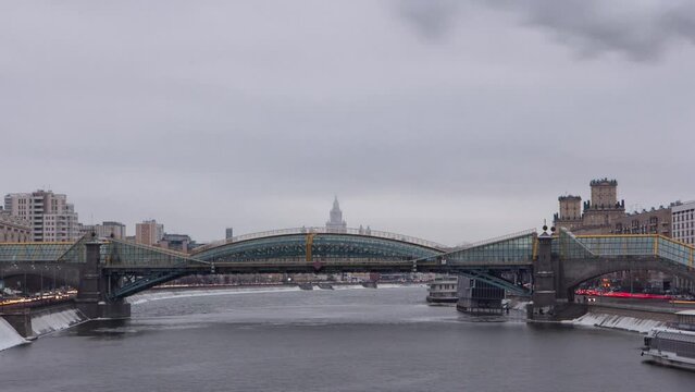 Winter Timelapse Hyperlapse of Pedestrian Bogdan Khmelnitsky Bridge in Moscow, Russia. Built in 1907, Reconstructed in 2000-2001, and Renamed in 2004. Night Scene with Illuminated Cityscape.