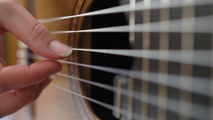 Female Guitarist Playing Song on Classical Guitar Close Up