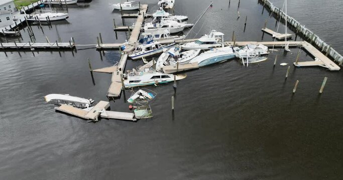 Damaged marina and sunken boats post hurricane Ian