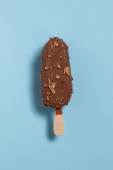 Ice cream covered with chocolate and almonds on a blue background	