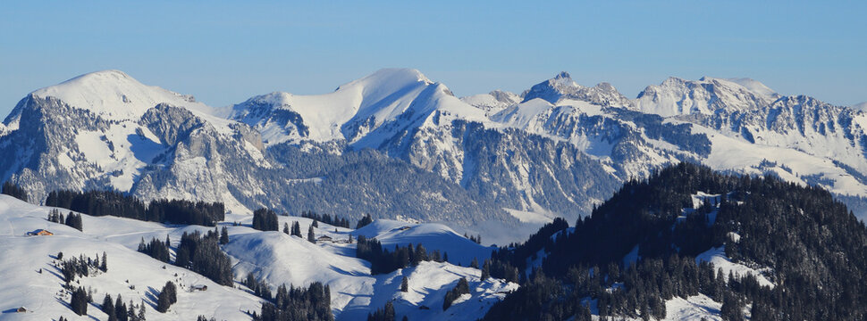Snow covered mountains Schafberg and Kaiseregg. Winter landscape near Zweisimmen, Swiss Alps..