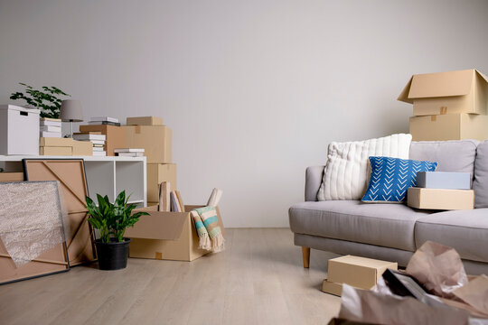 Image of decorative items, furniture, boxes and other items being moved into the new house.