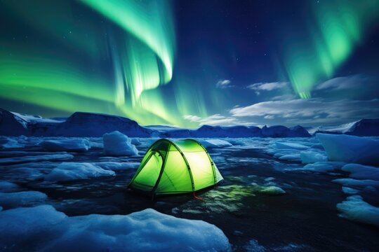outdoor adventure camping tent with aurora borealis polar light sky on mountain view in winter