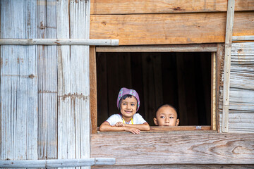 Tourists wearing hill tribe clothes. An Akha on the window. Tourists wearing Hmong hill tribe clothes.