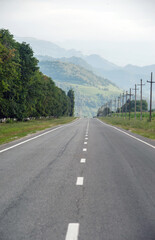 Fototapeta na wymiar Beautiful empty asphalt road against the backdrop of mountains in summer