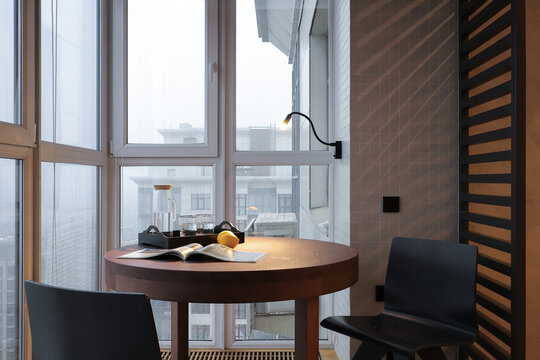 Table with chairs in the loggia in the apartment interior
