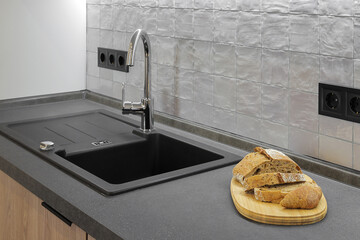 Faucet and granite sink in the kitchen