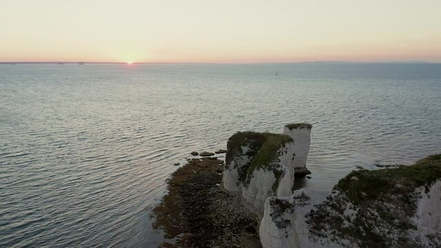 Backwards reveal of white chalk cliffs known as Old Harry rocks in Dorset, England's Jurassic coast 