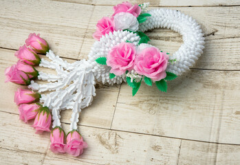 Beautiful Thai garland on a wooden background It has been a sacred object since ancient times.