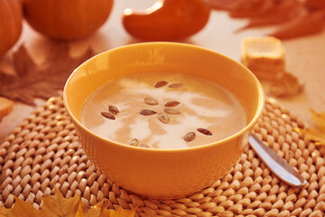 Seasonal autumn vegetarian pumpkin cream soup with seeds and plant-based cream