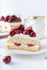 Decor for a pie made of fresh cherries and cream. Cake with cherries and vanilla cream. Summer fruits on a white background.