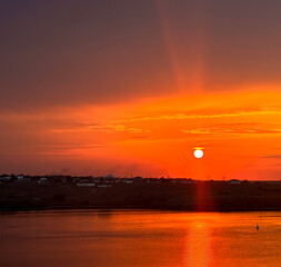 sunset over a lake. the superb reflection of the sun in the lake at sunset. Red. landscape.