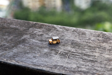 Miniature wooden car in a outdoor setting