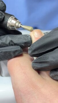 Pedicure master uses nail clippers while cutting toenails in pedicure salon. High quality 4k footage