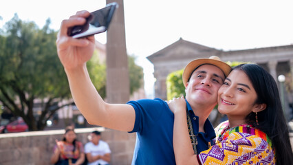Couple in love take a selfie and smile.
