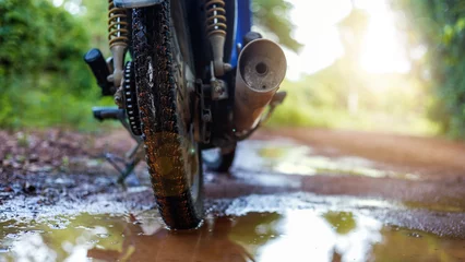 Foto auf Acrylglas A small motorcycle that drives through mud. © MOUNTAIN