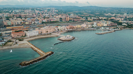 Fototapeta na wymiar Aerial panorama of Civitavecchia. Photo of the town with crystal clear sea and warm light.