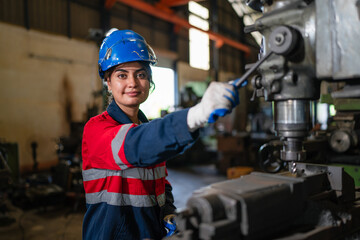 Portrait of female automation engineer standing in modern industrial factory and looking camera in...