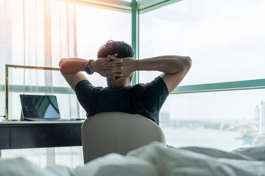 Life-work balance and living life style concept of businessman relaxing, take it easy in hotel or office room resting with thoughtful mind thinking of lifestyle quality looking forward to city