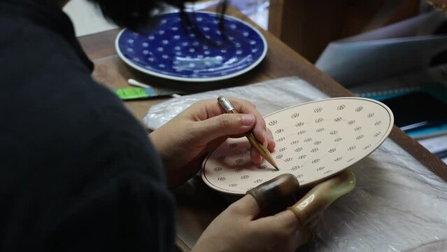 Artisan painting in Genemongama porcelain atelier, Kyushu region, Arita, Japan