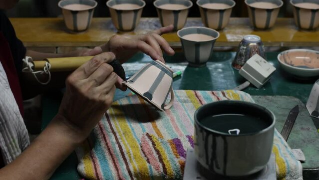 Artisan painting in Genemongama porcelain atelier, Kyushu region, Arita, Japan