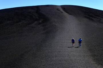 People Tourists Hiking on Inferno Cone at Craters of the Moon National Monument © Lane Erickson