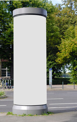 Empty advertising pillar in a city with white  free copy space, promotion mock up. Blank...
