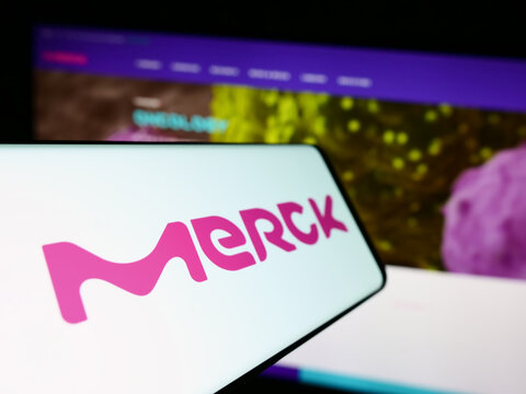 Stuttgart, Germany - 09-17-2023: Smartphone with logo of German pharmaceutical company Merck KGaA on screen in front of business website. Focus on center-left of phone display.