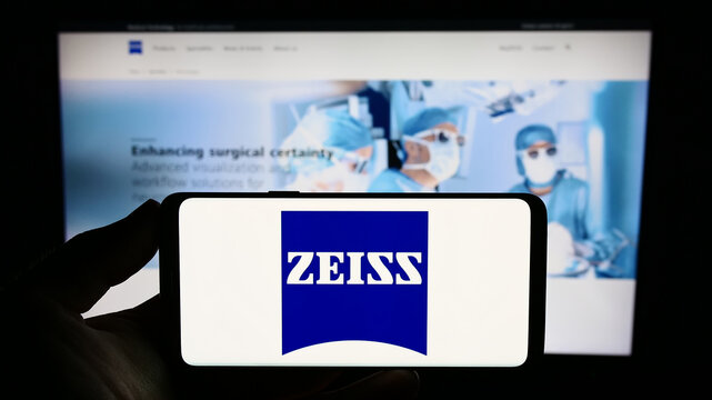 Stuttgart, Germany - 09-17-2023: Person holding smartphone with logo of medical technology company Carl Zeiss Meditec AG on screen in front of website. Focus on phone display.