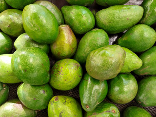 Pile of fresh avocados for sale on the market