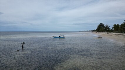 Fototapeta na wymiar Paradise beach in Indonesia with boat on the sand (Mavic Mini 3 Pro)