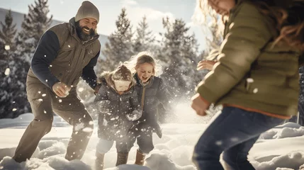 Fotobehang Familias felices jugando en la nieve en invierno © cuperino