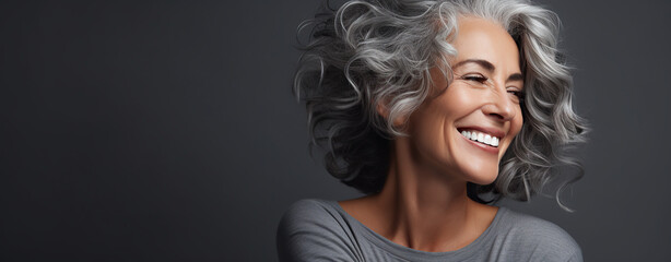 Beautiful 50s mid aged mature black woman with grey afro looking at camera isolated on grey background. Mature healthy old lady skincare, makeup and cosmetics, ai - obrazy, fototapety, plakaty