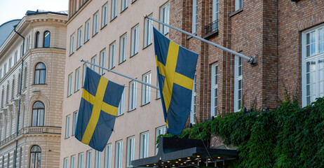 Sweden national flags waving on a Stockholm city building facade