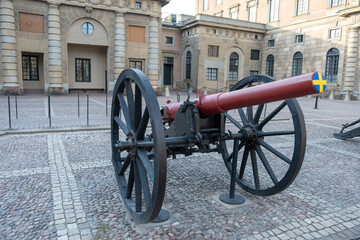 Antiwar concept. Canon covered and closed with Swedish flag cover at Royal Palace Stockholm Sweden.