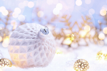 Christmas ball on a snow with decorations and flares