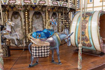 Vintage carousel: Whimsical ride from the past, adorned with colorful horses and ornate details, exuding timeless charm.