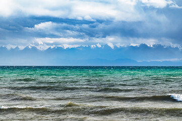 Fototapeta na wymiar Issyk-Kul after rain. View of the mountains on the opposite bank.