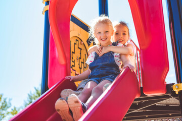 Happy kid slide on playground on summer season