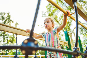 Fototapeta na wymiar Happy kid on playground on summer season