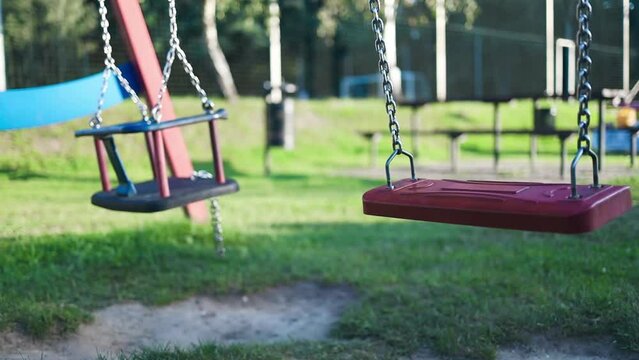 Playground swing set. Children swing in the park. High quality FullHD footage
