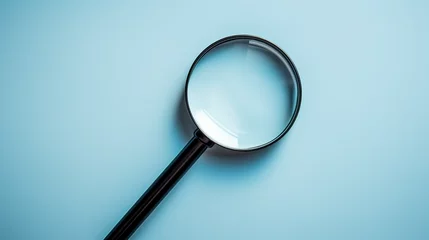 Fotobehang Black magnifying glass with light blue background. Top view, copy space background, business concept. © best stock