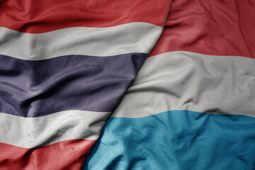 big waving national colorful flag of thailand and national flag of luxembourg . - obrazy, fototapety, plakaty