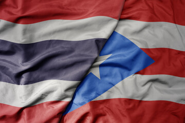 big waving national colorful flag of thailand and national flag of puerto rico .