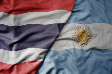 big waving national colorful flag of thailand and national flag of argentina .