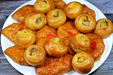 Background of Mini baked Danish pastry stuffed and topped with honey sugary sweet syrup and cherry...