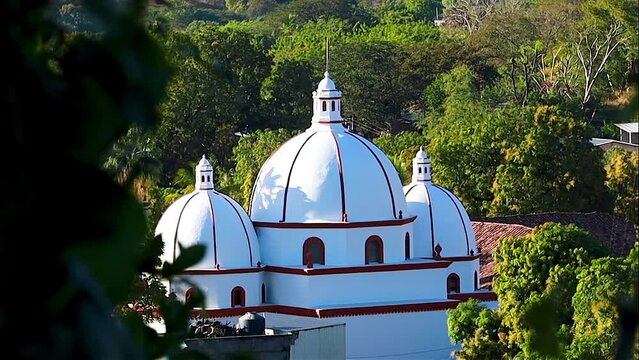 Sunset light giving tridimensional aspect to a church thas has three domes, the second oldest in Latin America